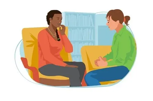 Two women sat in chairs talking.