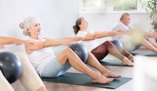 A group of older adults exercising on mats