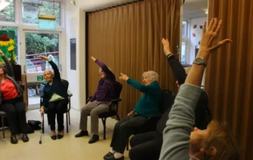 Older adults participating in chair based yoga