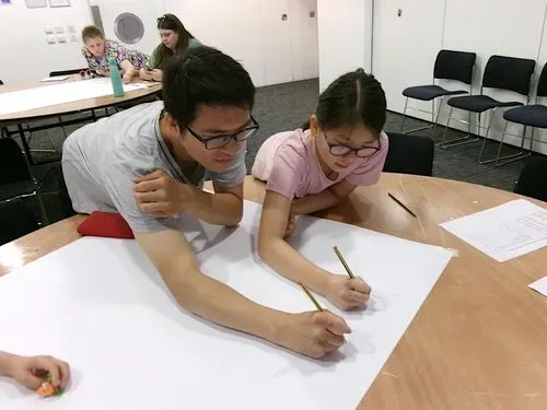 An adult and child working on a project together.