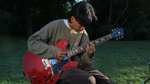 boy playing the guitar