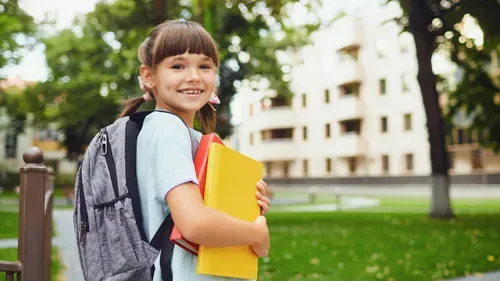Child holding a folder going to school