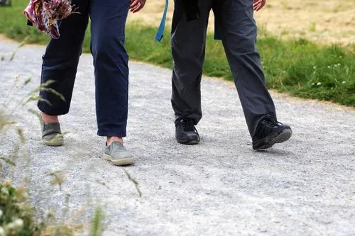 Two pairs of legs walking along a path