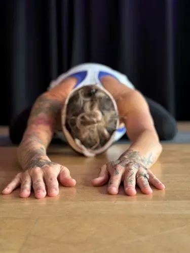 Pilates teacher stretching
