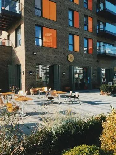Building with orange panels and café shop window.
