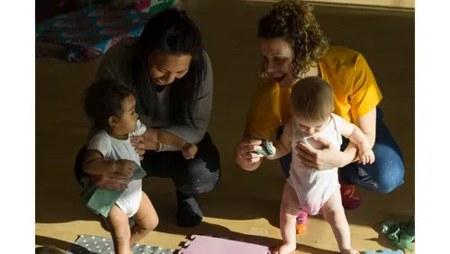 Two parents playing with their children