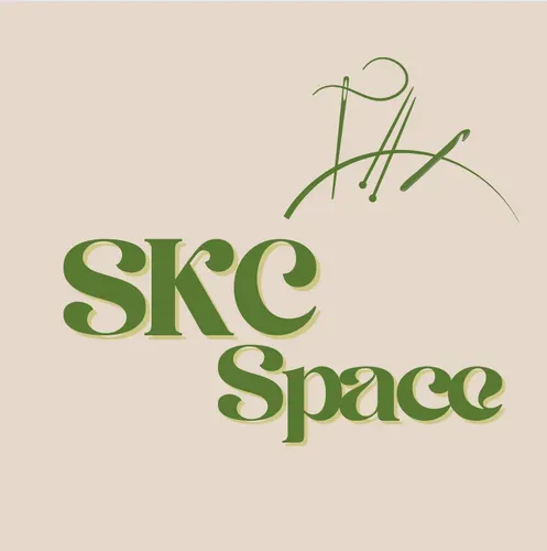 The logo shows the words “SKC Space” in bold, friendly lettering. Next to the text is a simple illustration of a sewing needle, knitting needles, and a crochet hook.