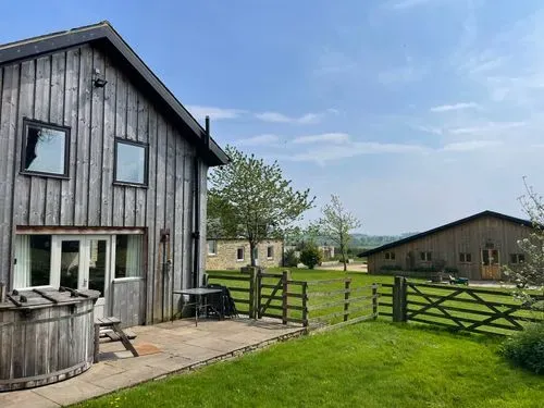 a wooden barn and blue skies