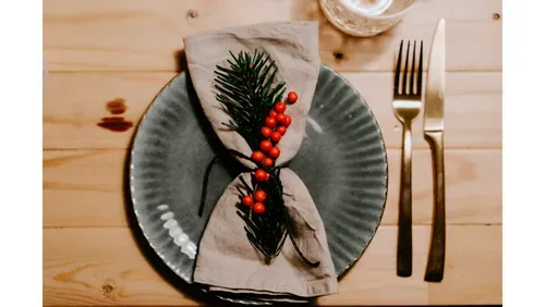 plate, knife and fork, holly and wine. 