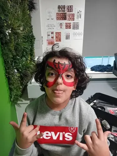 A young person at WEST after getting his face painted!