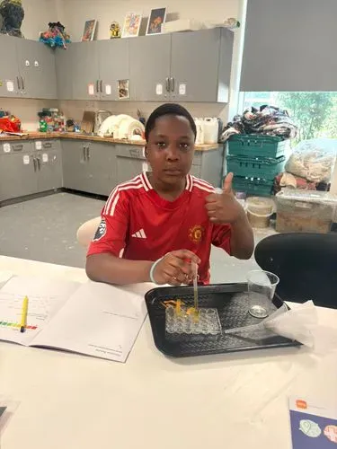 Young person taking part in GSK science activity in May half term