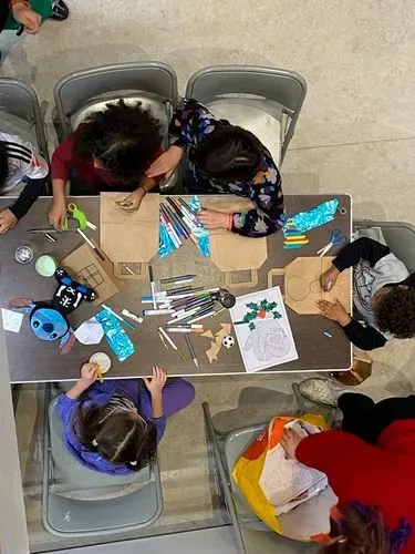 young people doing Christmas crafts seen from above