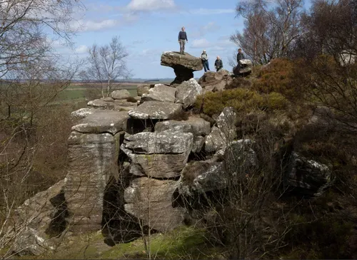 people standing on large stone