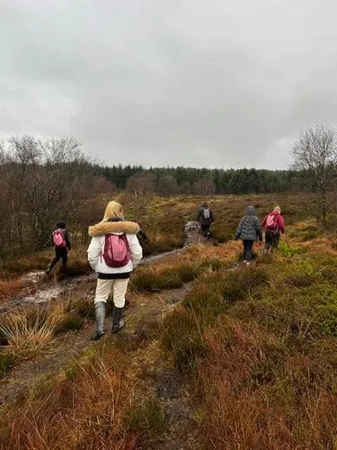 young people walking across moorland