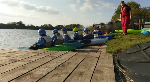 children sitting on pier