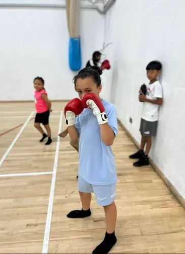 one of the children with boxing gloves on