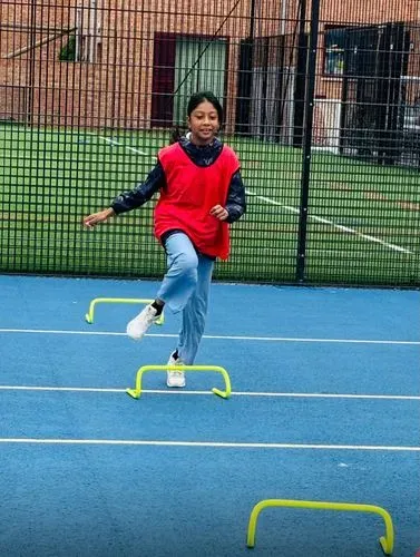 one of the children running over hurdles