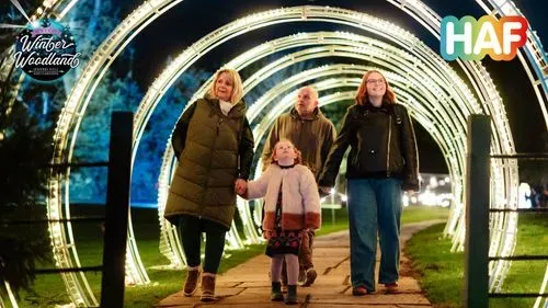 Family walking through the light arch