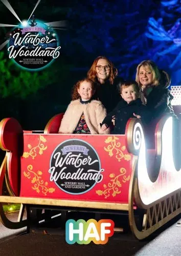 Sewerby Hall lit up with people walking