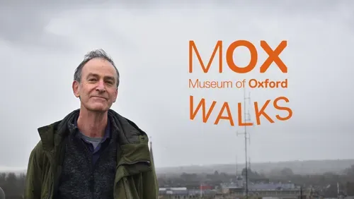 A photo of tour guide Mark Davies against the Oxford skyline. He is wearing a green jacket.