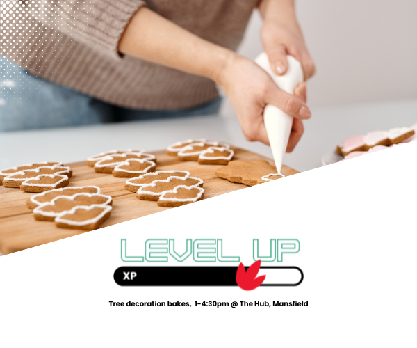 person icing christmas tree cookies