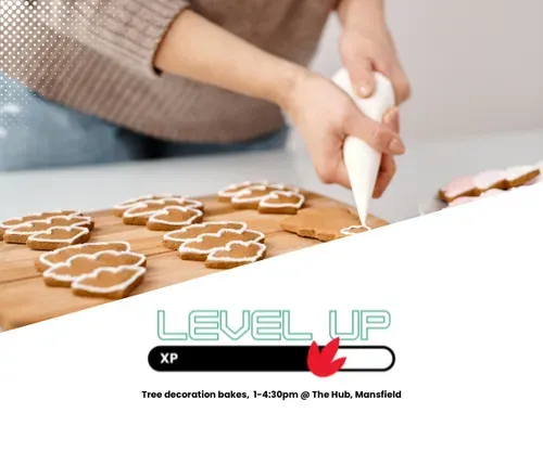 person icing christmas tree cookies