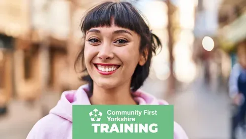 Young woman smiling to camera in a high street setting