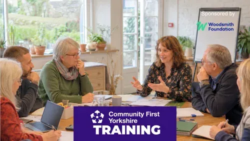 Group of people in a meeting setting talking around a table with the Community First Yorkshire logo and the word Training against a purple colour block