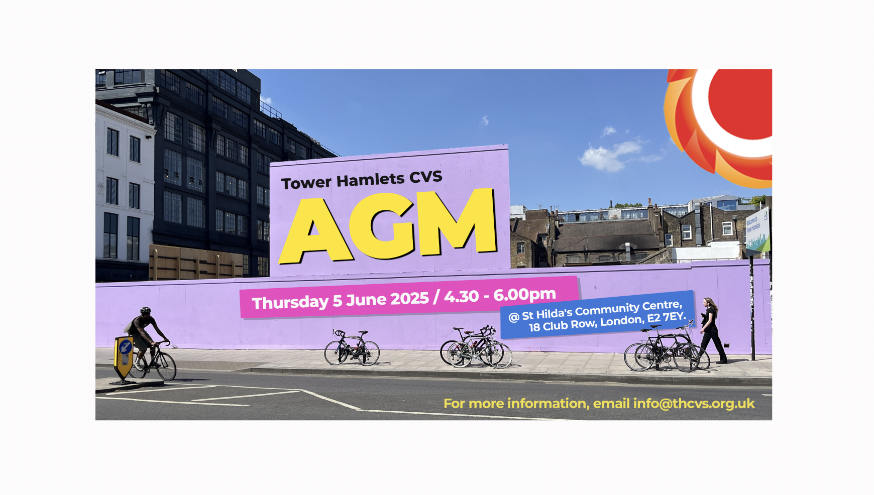 Photograph of a light purple billboard in Shoreditch. One person is cycling and one person is walking. Bikes are parked on the street. Text on the billboard: Tower Hamlets CVS AGM (in bright yellow) Thursday 5 June / 4.40 to 6.00pm / St Hilda's Community Centre, 18 Club Row London, E2 7EY written in pink and blue boxes. THCVS logo in the top right corner. For more information, email info@thcvs.org.uk.