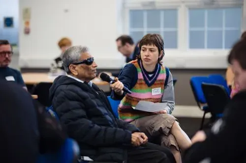 This photo shows Mahendra, a panel member of the Cornerstone project and Grace holding a microphone 