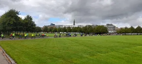 People cycling through Glasgow Green