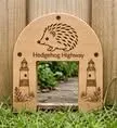 Hedgehog Highway.  A small hedgehog siezed face plate to allow hedgehogs to go through fences safeley.