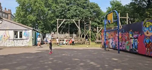 Children play football outside on a tarmac playground