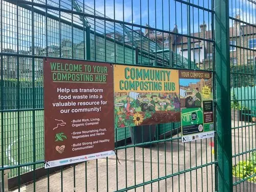 Composting hub sign on a fence