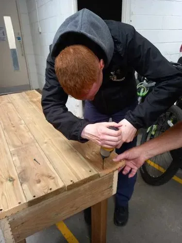 Our volunteers working together to build wooden tables from decking boards for our education room at Jarrow Hall.