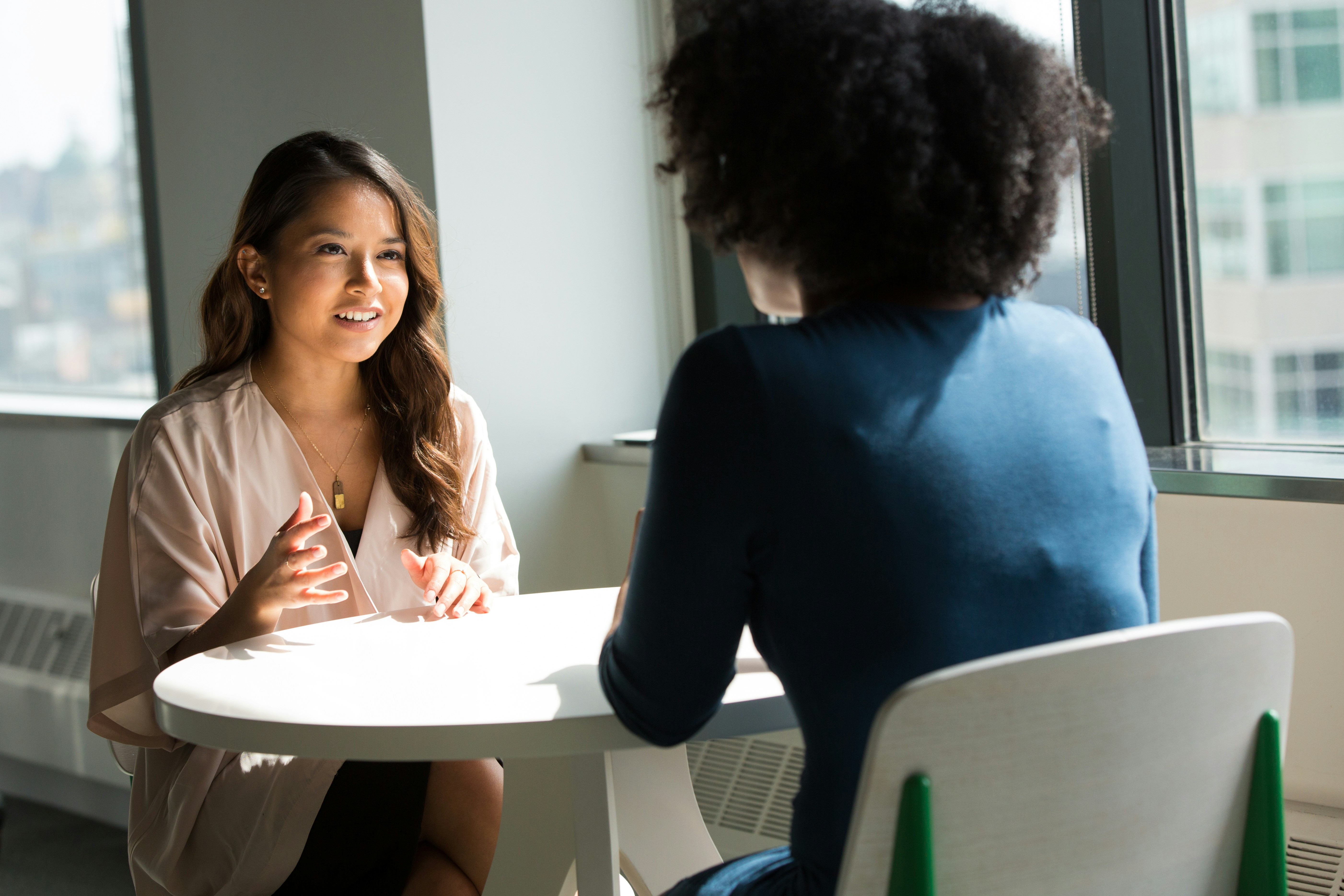 Two people talking sitting down