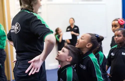 Children taking part in an interactive first aid training session with a St John Ambulance instructor.