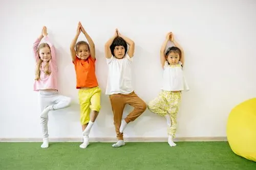 four children in a yoga pose